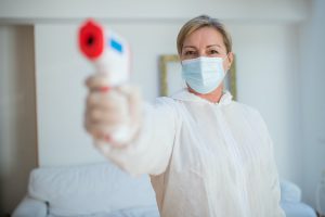 woman holding digital thermometer
