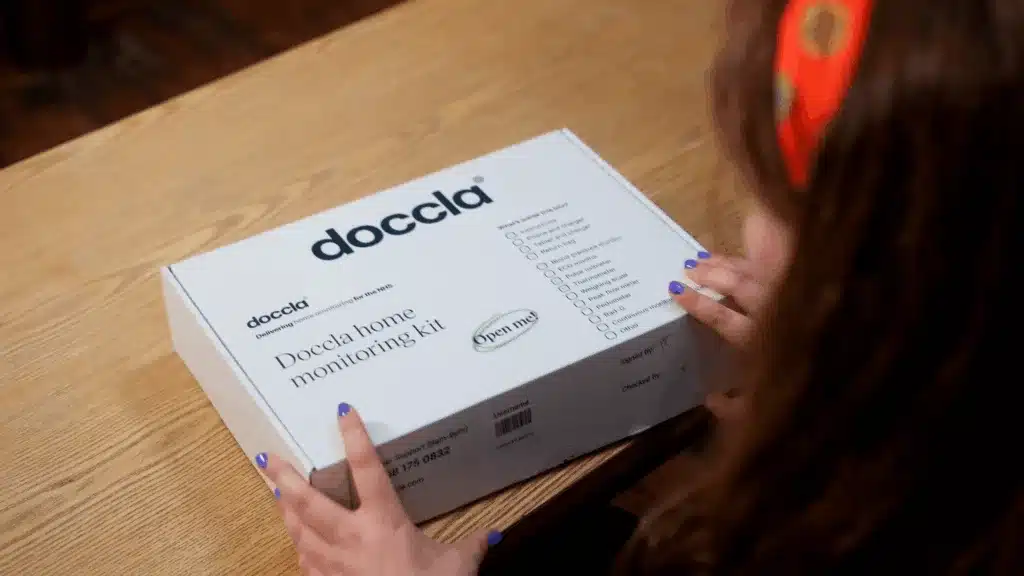 Person opening home monitoring kit